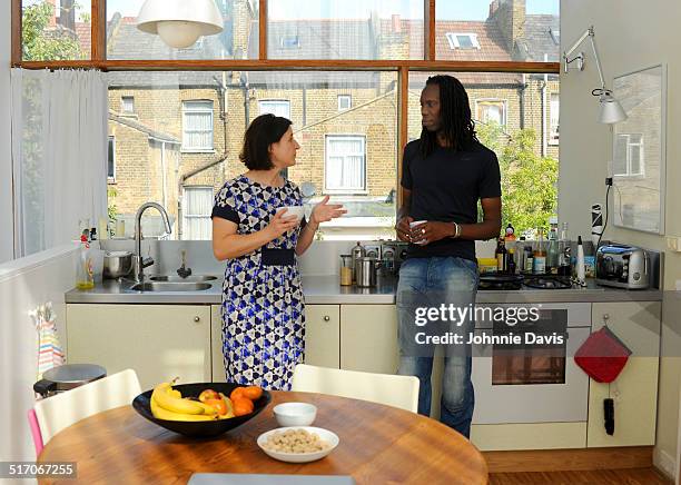 mature mixed race couple chatting in the kitchen - 4931 stock pictures, royalty-free photos & images