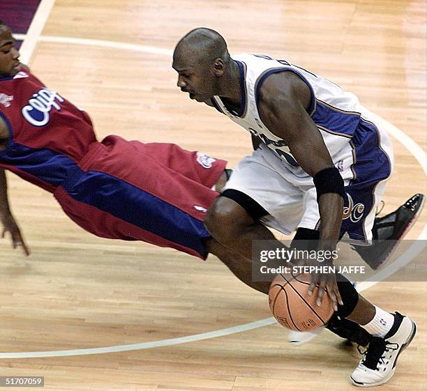 Washington Wizard's Michael Jordan goes up against Los Angeles Clipper's Corey Maggette during first quarter action 08 January 2002 at the MCI Center...