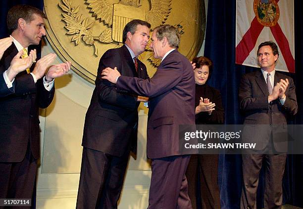 President George W. Bush hugs his brother Jeb before speaking at a Jeb Bush for Florida Governor fundraising event 09 January 2002 at the Capitol...