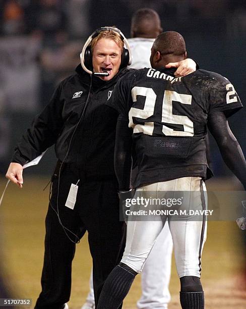 Oakland Raiders head coach Jon Gruden greets Raiders runningback Charlie Garner after Garner ran an 80-yard, fourth-quarter touchdown against the New...