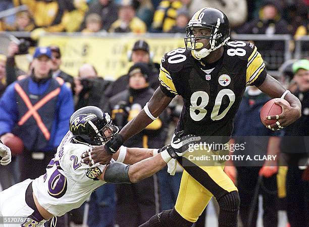 Pittsburgh Steelers' Plaxico Burress breaks away from Rod Woodson of the Baltimore Ravens to score a touchdown in the 4th quarter during the AFC...