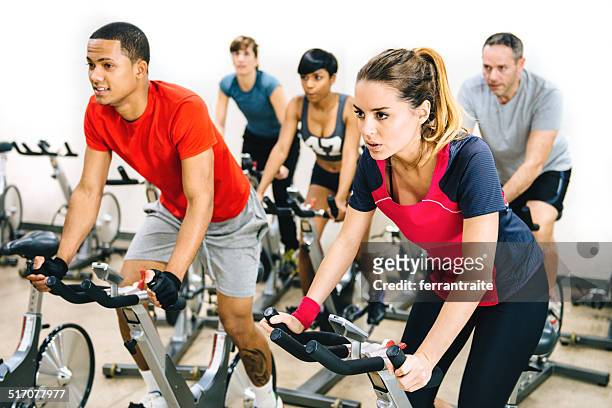 exercising class - stationary cycling class stock pictures, royalty-free photos & images