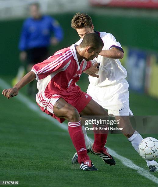 Mario Rodriguez from Cuba and DaMarcus Beasley from the US fight for the ball during the second half of the Gold Cup's match at the Rose Bowl in...