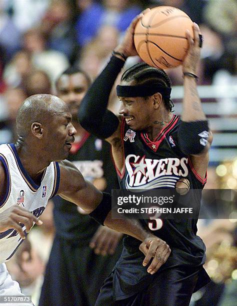 Philadelphia 76ers' Allen Iverson holds the ball against Washington Wizards' Michael Jordan during the second quarter of action 22 January 2002 at...