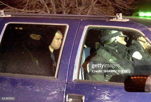 Taliban fighter John Walker Lindh rides in the back seat with security officers 23 January as they arrive at the Alexandria Detention Center in...