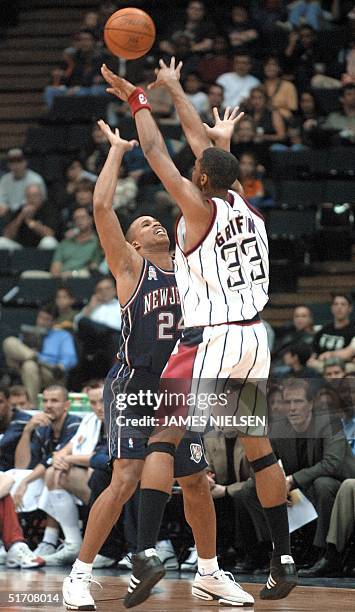 Houston Rocket Eddie Griffin shoots over the New Jersey Nets Richard Jefferson in the first quarter at the Compaq Center 24 January 2002 in Houston,...