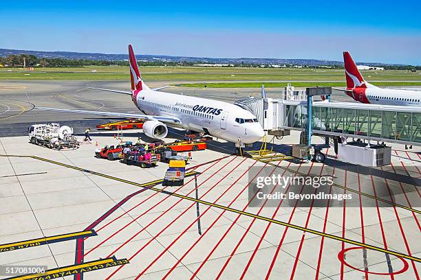 on the tarmac, qantas aircraft being prepared for next flight - airport crew stock pictures, royalty-free photos & images