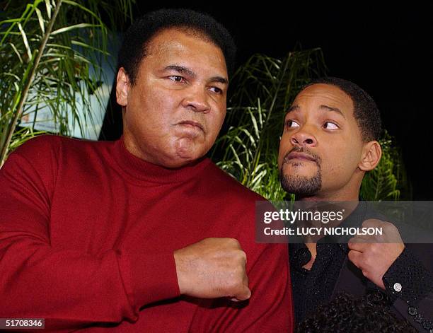 Former world heavyweight boxing champion Muhammad Ali jokes with US actor Will Smith who portrays him in new film "Ali," at the movie's premiere in...