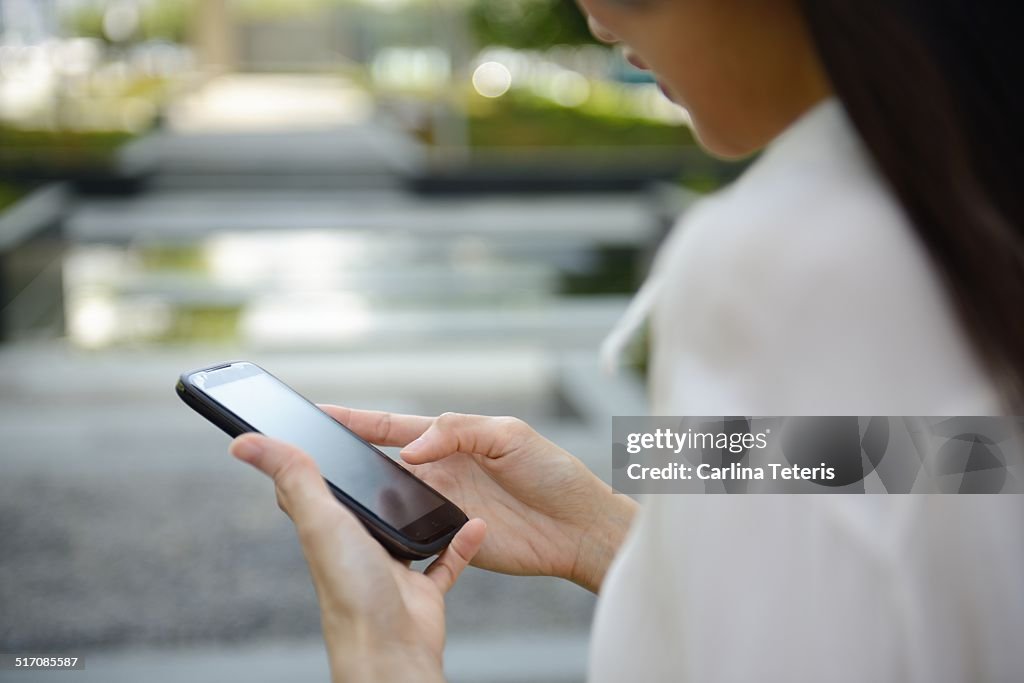 Young woman holding smart phone