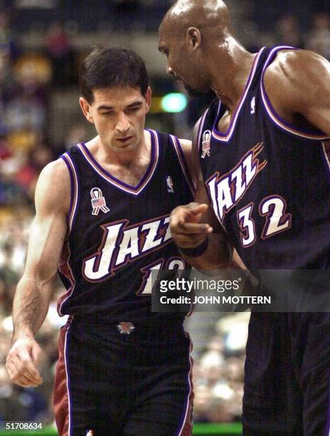 John Stockton and Karl Malone of the Utah Jazz plan their offense against the Boston Celtics in the first half of action 21 December 2001 at the...
