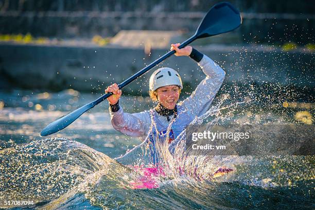 female kayaker paddling in whitewater - white water kayaking stock pictures, royalty-free photos & images