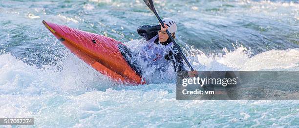 female kayaker paddling in whitewater - canoeing and kayaking stock pictures, royalty-free photos & images
