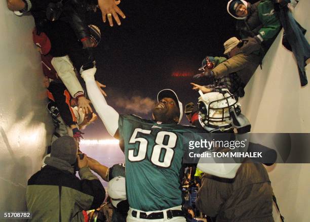 The Philadelphia Eagles Ike Reese greets joyous fans as he leaves the field after the Eagles 24-21 win over the New York Giants with a 34 yard field...