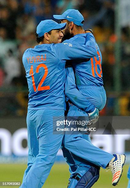 Yuvraj Singh of India and Virat Kholi of India congratulate team captain M S Dhoni after the win during the ICC World Twenty20 India 2016 match...