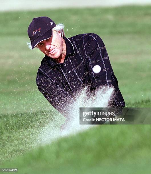 Australian golfer Greg Norman blasts from a sand trap on the 12th hole during the Skins Game at the Landmark Golf Club in Indio, California, 25...