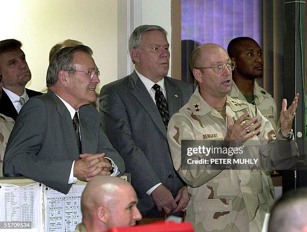 Secretary of State Donald H. Rumsfeld listens to US Air Force Major General Gene Renuart , director of Operations at Central Command, 27 November...