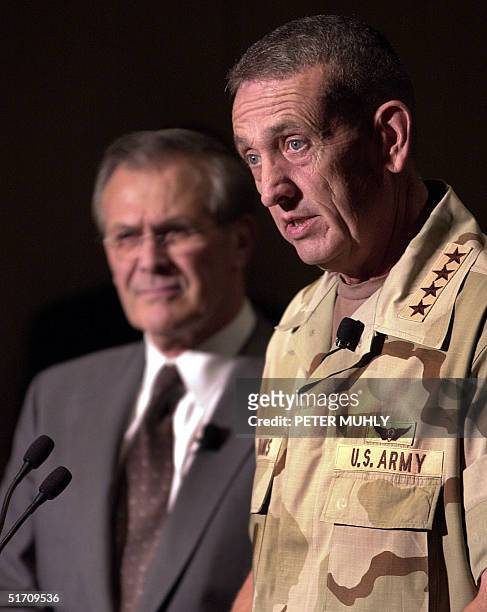 United States Secretary of State Donald H. Rumsfeld as US Army General Tommy R. Franks talks with the media 27 November 2001 before giving the...