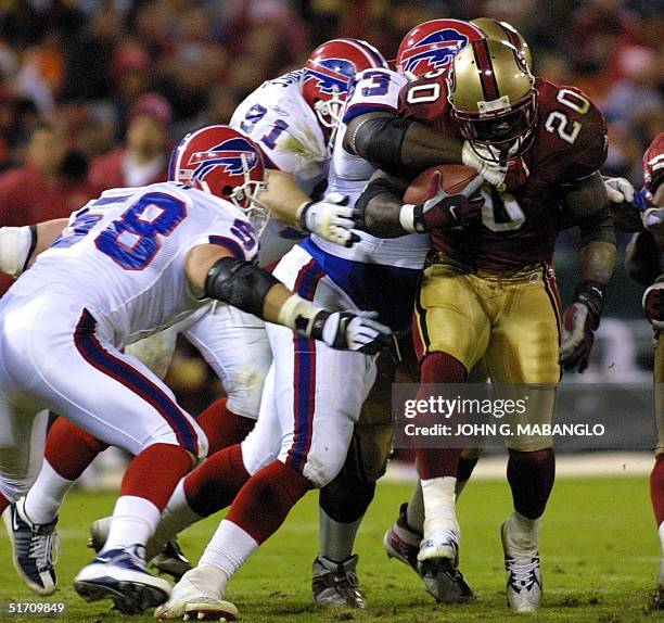 San Francisco 49ers' runningback Garrison Hearst is tackled by Buffalo Bills' defensive tackle Pat Williams , defensive end Shawn Price and...