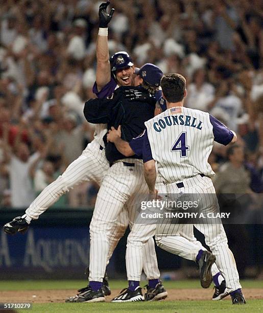 Arizona Diamondbacks left fielder Luis Gonzalez is congratulated by starting pitcher Curt Schilling and Craig Counsell after Gonzalez hit an RBI...