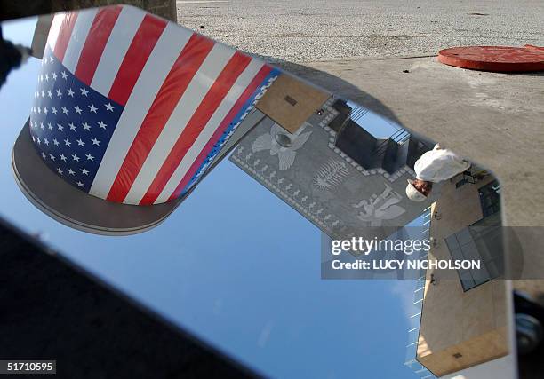 The new Hollywood & Highland retail and entertainment complex is reflected in a security mirror to check for car bombs, as it opens to the public, in...