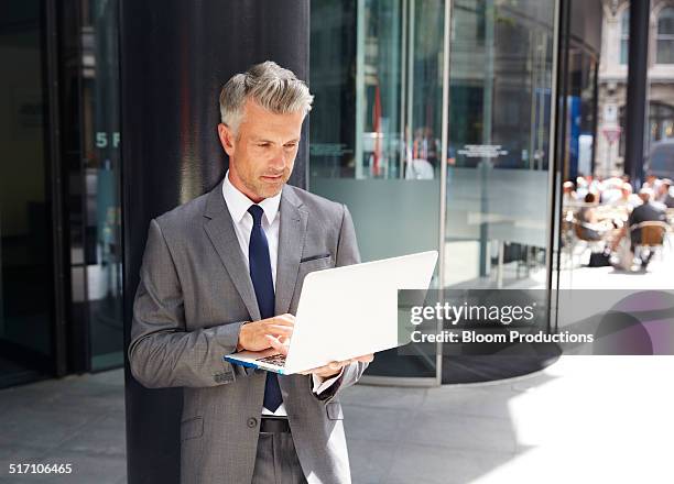 Man Using Tech 10,333 Middle Aged Man Holding Laptop Stock Photos, High-Res Pictures ...