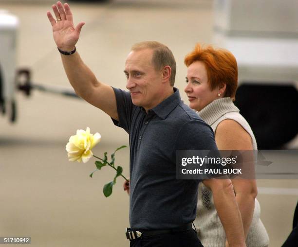 Putin Wave Russian President Vladimir Putin waves to several hundred cheering ...