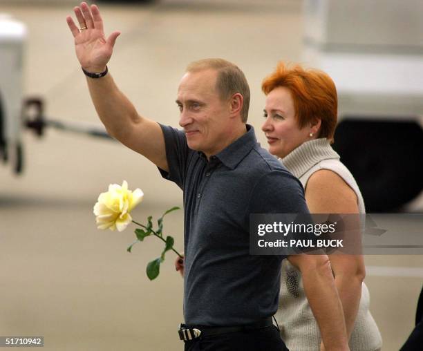 Russian President Vladimir Putin waves to several hundred cheering spectators upon his arrival at Texas State Technical College airport in Waco,...