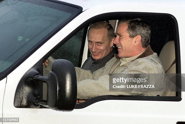 President George W. Bush dives Russian President Vladimir Putin from Putin's helicopter 14 November 2001 at the Bush's ranch in Crawford, Texas....