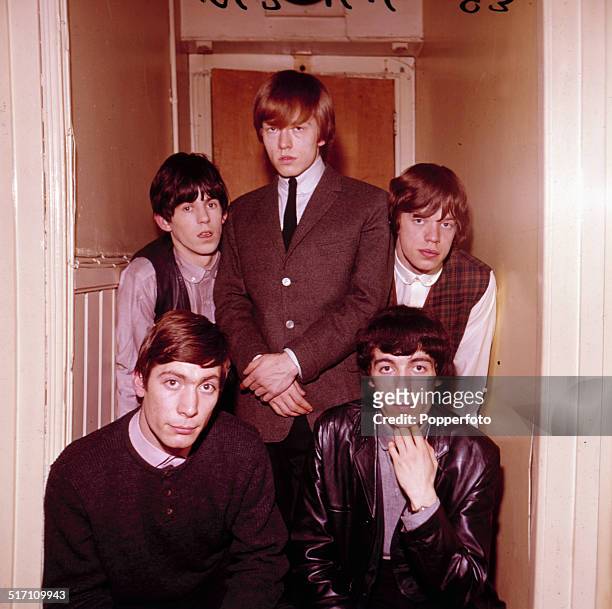 English rock and roll group The Rolling Stones in a doorway in 1963. Clockwise from bottom left: Charlie Watts, Keith Richards, Brian Jones , Mick...