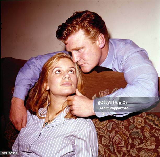 Welsh actor Donald Houston posed with English actress Joanna Dunham on the set of the television drama 'Love Story - Commutors' in 1964.
