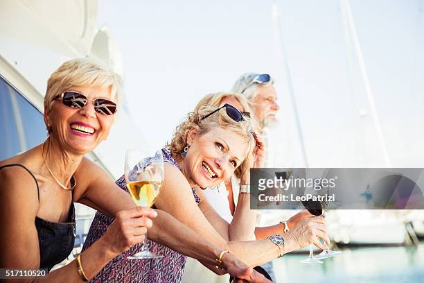 group of senior friends drinking wine on a yacht - boat old stock pictures, royalty-free photos & images