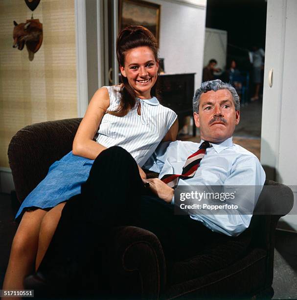 English actor Kenneth More pictured with actress Francesca Annis on the set of the television drama 'Armchair Theatre- Old Soldiers' in 1964.