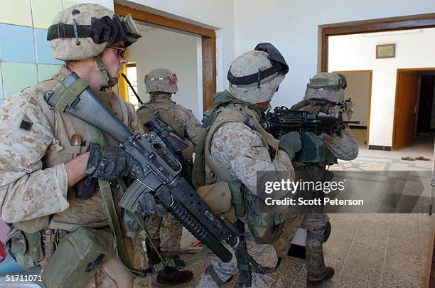 Marine scouts of the Light Armor Reconnaissance try to secure a building November 9, 2004 in Fallujah, Iraq. On the authority of Iraqi President Ayed...