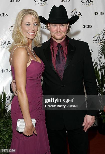 Tracy Lawrence and his wife Becca Lawrence arrive at the 38th Annual CMA Awards at the Grand Ole Opry House November 9, 2004 in Nashville, Tennessee.