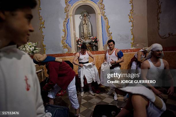 Penitents take part in the "Jesus de las Tres Caidas y Nuestra Senora del Rosario" brotherhood procession on March 23, 2016 in Granada, during the...