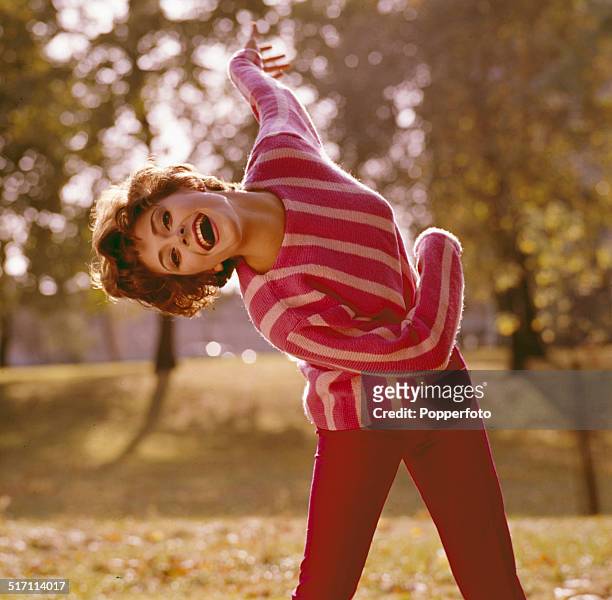 American actress Elizabeth Ashley posed wearing a striped pink jumper in London in 1965.