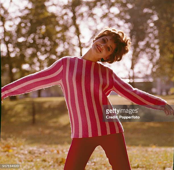 American actress Elizabeth Ashley posed wearing a striped pink jumper in London in 1965.