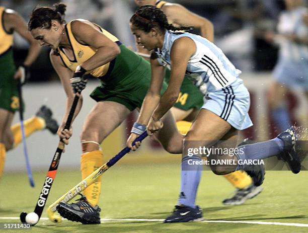 Argentine Soledad Garcia battles for the ball with Australian Emily Halliday during the field hockey match for the Champions Trophy in Rosario,...