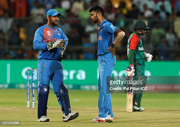 Dhoni of India has a word with Hardik Pandya of India as the latter gets ready to bowl the last over during the ICC World Twenty20 India 2016 match...