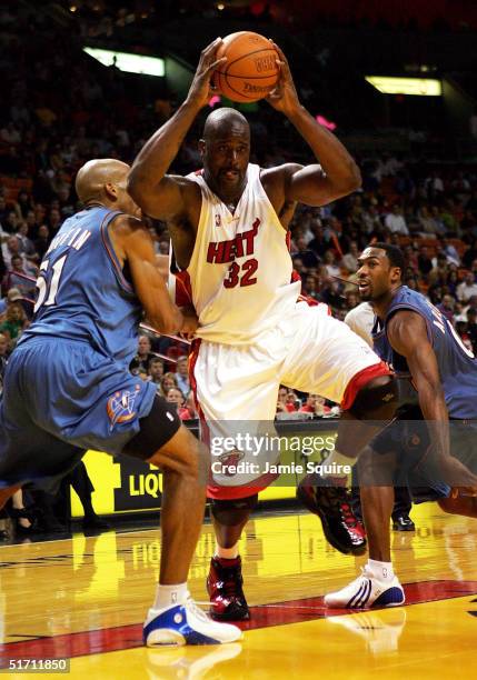 Shaquille O'Neal of the Miami Heat shoots over Michael Ruffin and Gilbert Arenas of the Washington Wizards on November 9, 2004 at American Airlines...