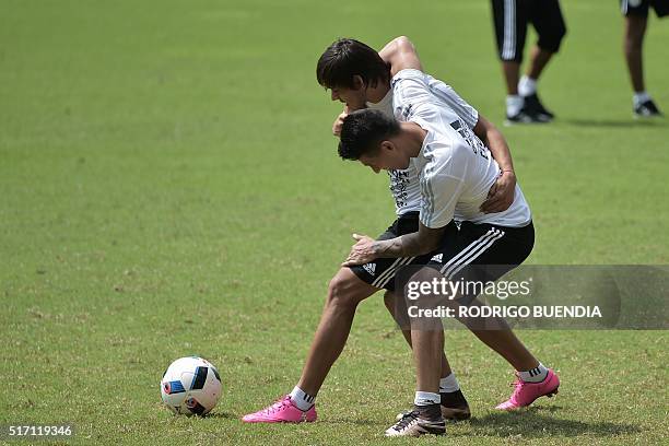 Paraguay's national football team players Oscar Romero and Hernan Perez take part in a training session in Guayaquil, Ecuador, on March 23, 2016....