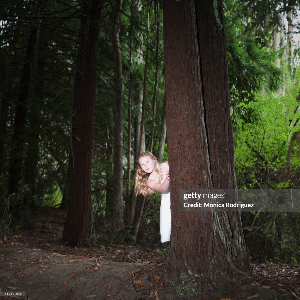Curious young girl in the forest