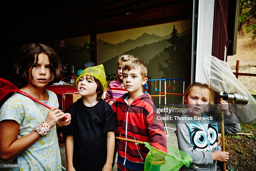 Group of young kids standing in doorway of barn
