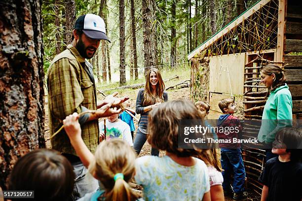 counselors giving instructions to kids at camp - sommercamp stock-fotos und bilder
