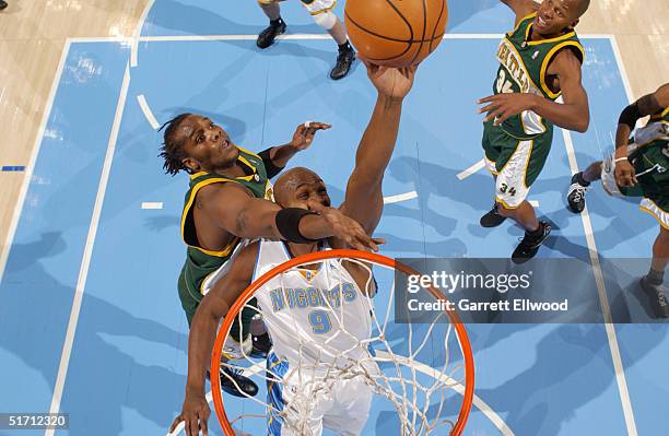 Danny Fortson of the Seattle Sonics fouls Bryon Russell of the Denver Nuggets on November 9, 2004 at Pepsi Center in Denver, Colorado. NOTE TO USER:...