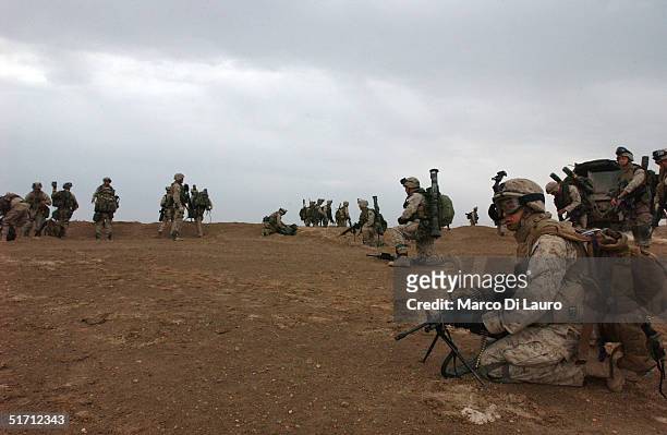 Marines from the 1st Marines Expeditionary Force, 1st Battalion, 3rd Marines Regiment, Bravo Company move to the line of departure of the ground...