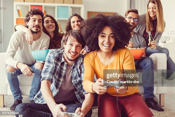 colleagues playing video games in the office relax room - ice breaking stock pictures, royalty-free photos & images