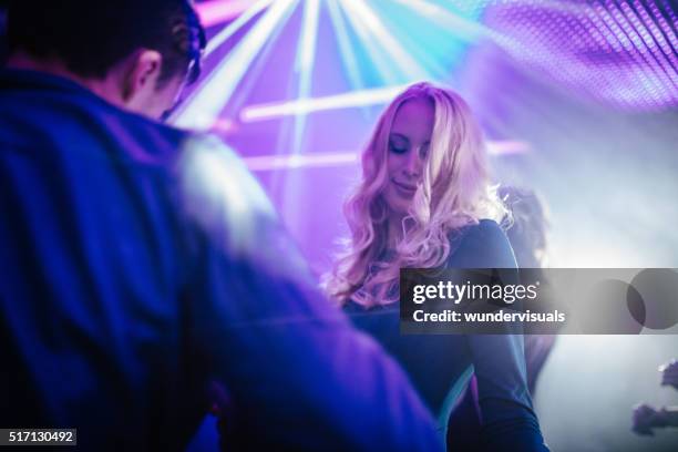happy girl dancing and flirting with boy in a club - girl flirting stock pictures, royalty-free photos & images