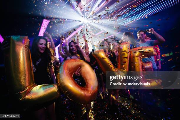 multi-ethnic young friends celebrating a night club party with ballons - dance floor stock pictures, royalty-free photos & images
