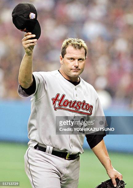 Houston Astros' Roger Clemens waves his cap to the audience as he leaves the pitching mound during the friendly match between the Major League...